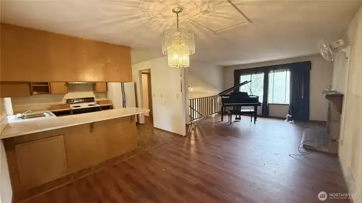 Looking from formal dining to functional kitchen