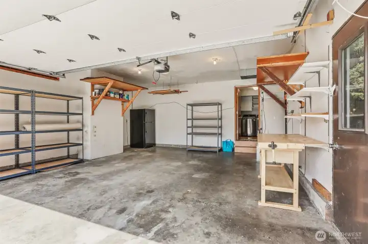 Two car garage with tons of storage and a brand new water heater. The garage fridge and shelving convey with the home.