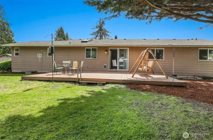 The glass sliders behind the dining table open to a huge deck and large, fully fenced backyard. The deck swing conveys with the house.