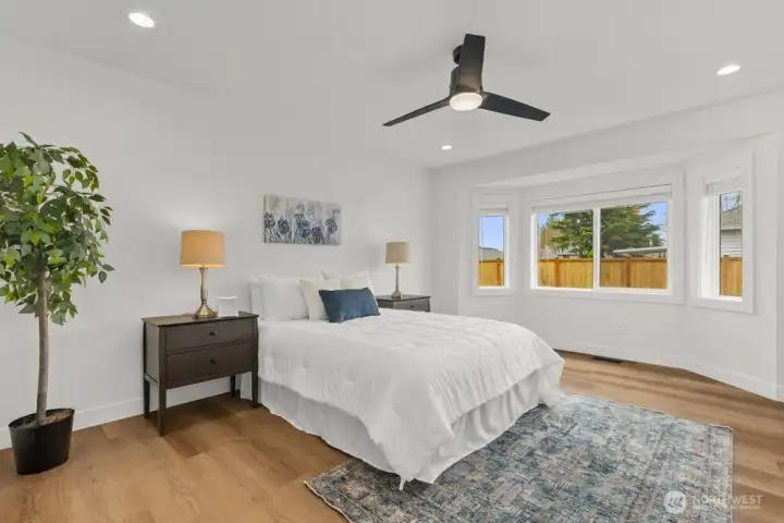 Large primary bedroom with bay window.