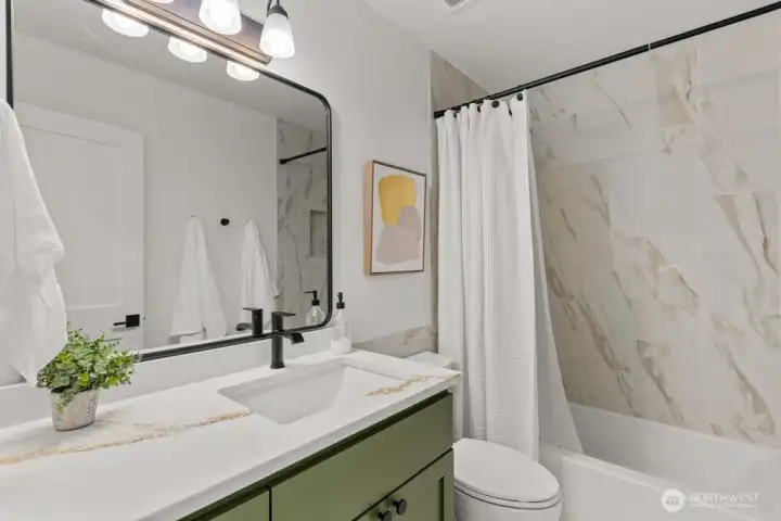 The full bath continues the theme with a beautifully finished Italian tile surround.