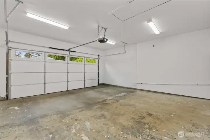 Painted garage with new door and a 240 outlet installed for Level 2 EV charger.