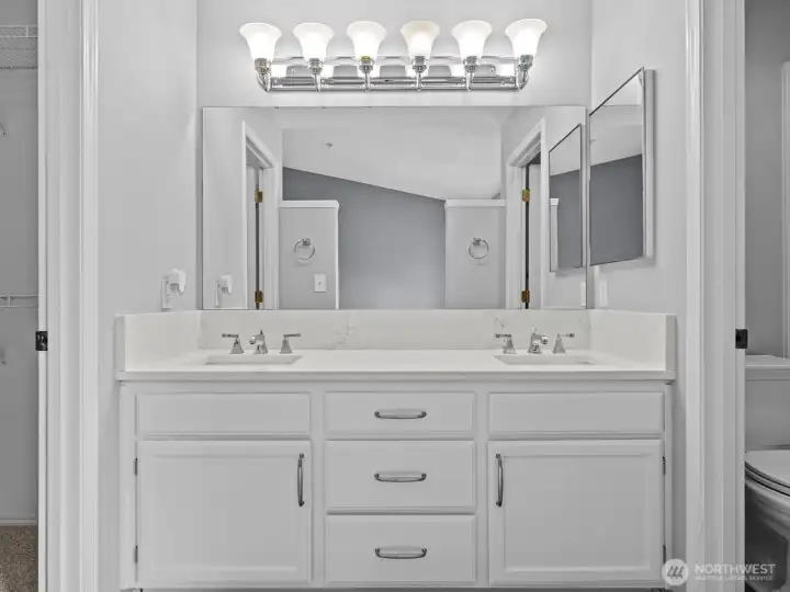 The vanity bridges the space between the walk-in closet and shower area. The vanity bridges the space between the walk-in closet and shower area.