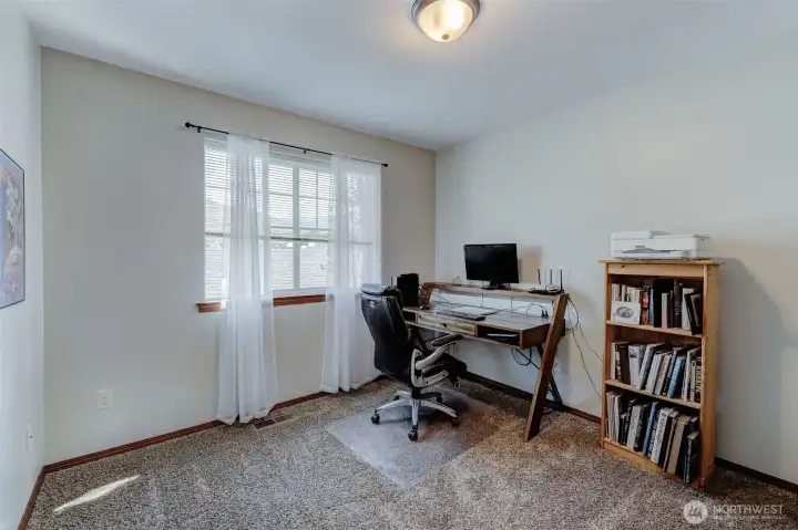 First of three upper bedrooms, used as an office.