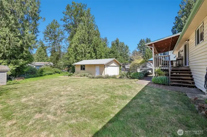 Backyard with detached garage and shed.