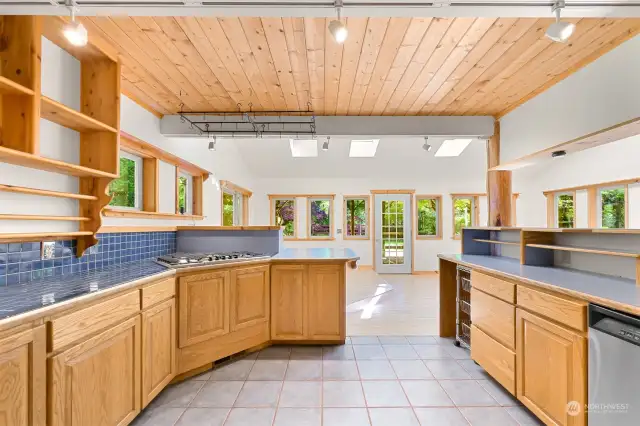 Chef's Kitchen with Bar Seating and Dining Room