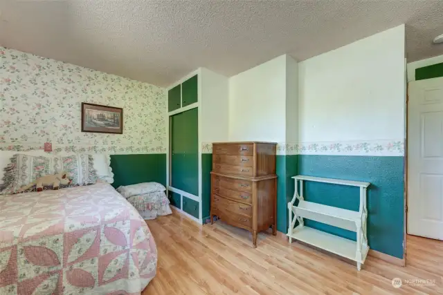 This bedroom is lined with windows that overlook the backyard!