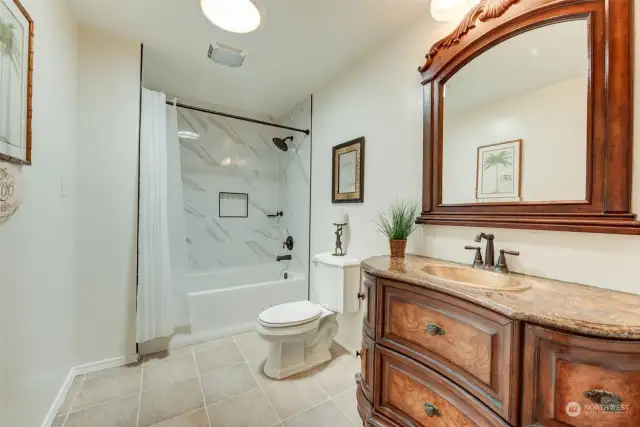 Sweet upgraded bathroom with designer tile & vintage looking vanity!