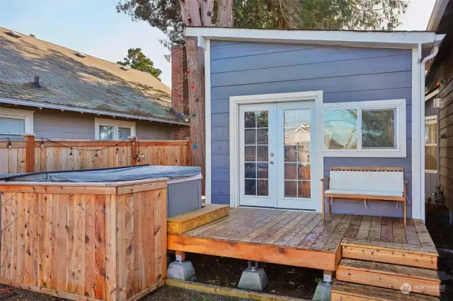 Exercise room with hot tub built into the deck