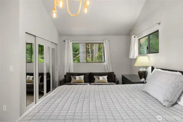 Main floor primary boasts a large area for a private sitting room