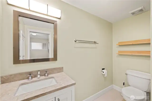 Good sized bath with built in cabinets.