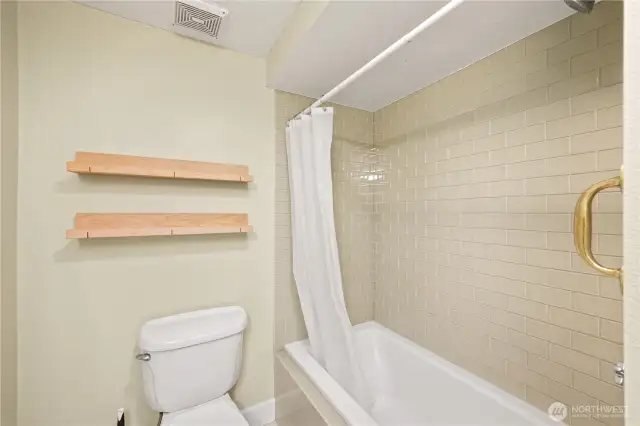 Deep soaking tub and tiled shower.