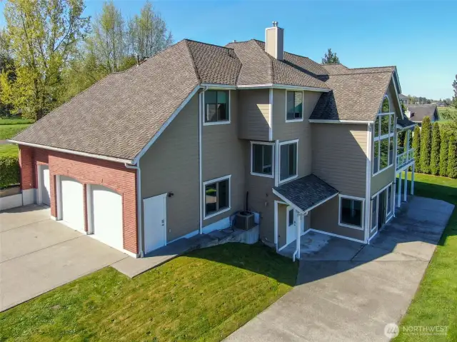 3 Car Garage and Drive around access to the back of the house. Basement/Storage