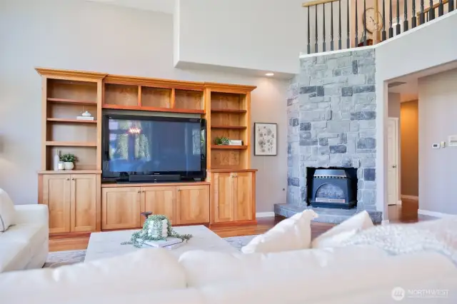 Cozy Stone Fire Place, above is the Walkway to Primary Bedroom.