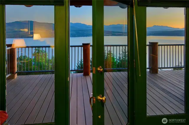 French doors off the primary suite lead to the deck and view.