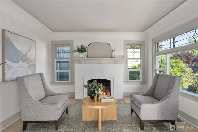 Cozy sitting room located just off of the living room with original fireplace