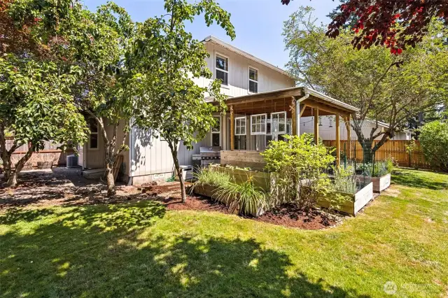 Large lot with fully-fenced backyard with covered patio and garden spaces