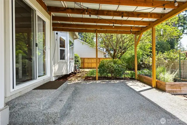 Large lot with fully-fenced backyard with covered patio and garden spaces