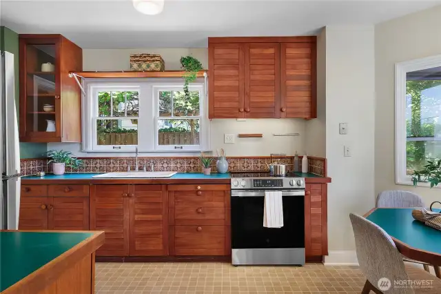Custom built teak cabinetry, with lots of light, new appliances, and tile backsplash.