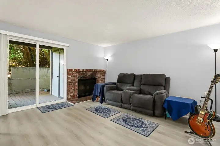 Sliding glass door onto private patio, backing to green space.