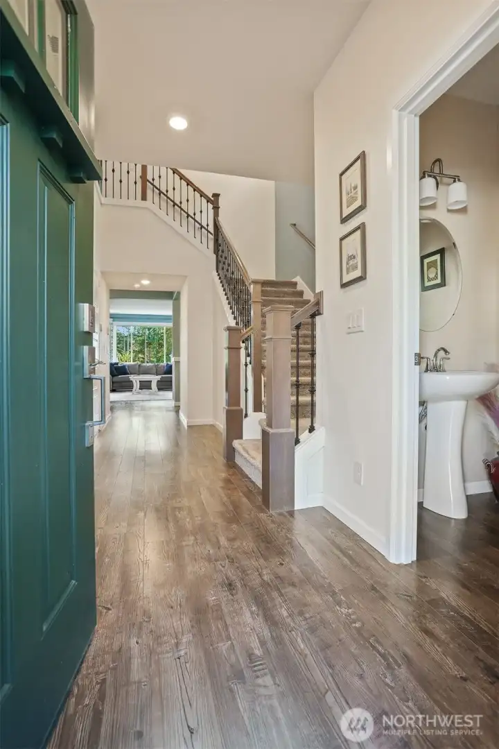Formal entry hallway with 1/2 bath on the right.