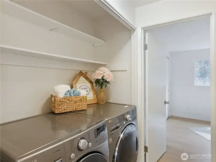 Newer full-sized washer & dryer in unit with extra storage.