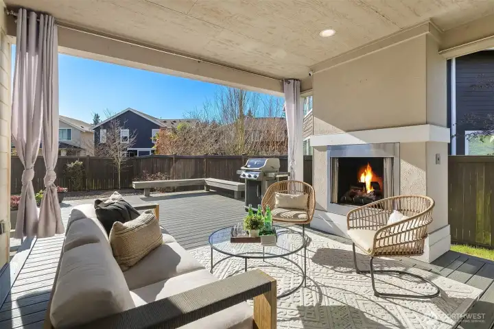 Covered deck with outdoor fireplace.