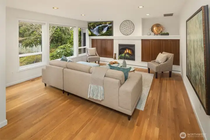 Relax and enjoy this spacious family room with hardwood floors, gas fireplace, built in cabinets,  a free wall mounted flat screen TV, and of course beautiful views out to the lake. There is also a door leading out to the back patio area.