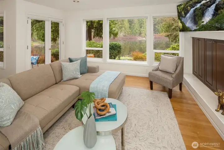 The Family Room w/ doors leading out to the back patio and the yard, and the lake!