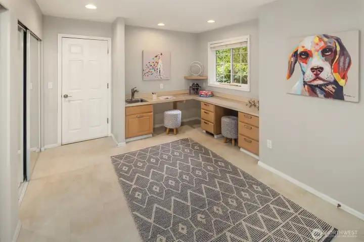 The Bonus Room as you come in from the garage. A perfect 2nd office area w/ built in desks, craft room, or mud room. Lots of storage closets to the left side with mirrored slider doors, plus another big closet to the right side  which is out of this photo.