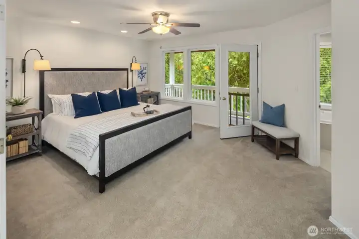 The Upstairs Primary Bedroom Suite with Juliette Balcony that overlooks the backyard and lake.