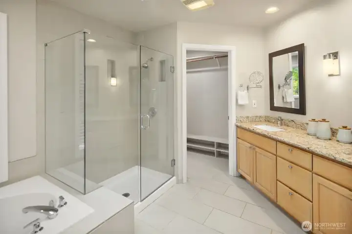 A larger seemless glass shower, corner soaking tub, dual sinks, skylight, and a big walk-in closet