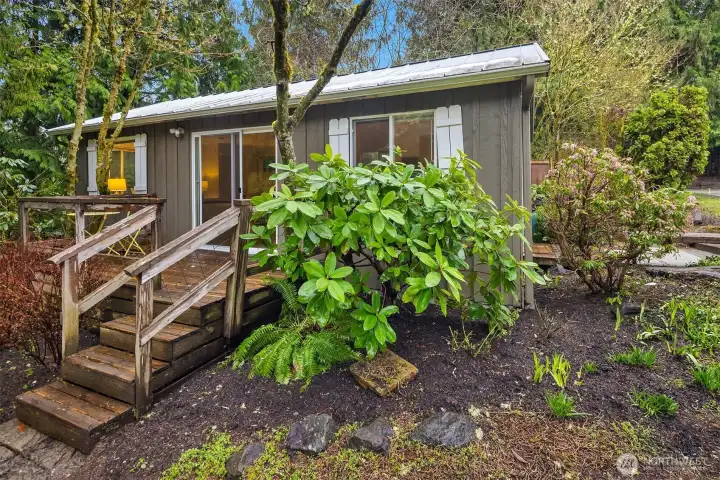 The deck coming down off from the cottage into the back yard