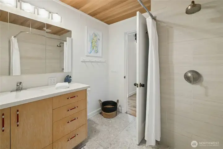 Main floor bath is updated with tiled walk in shower, flooring and lighting.