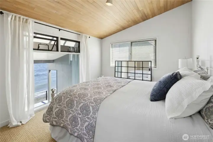 Upstairs second bedroom with vaulted ceiling and views.