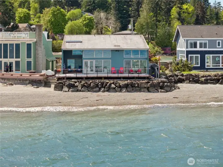 Waterside view of home capturing the full expanse of deck.