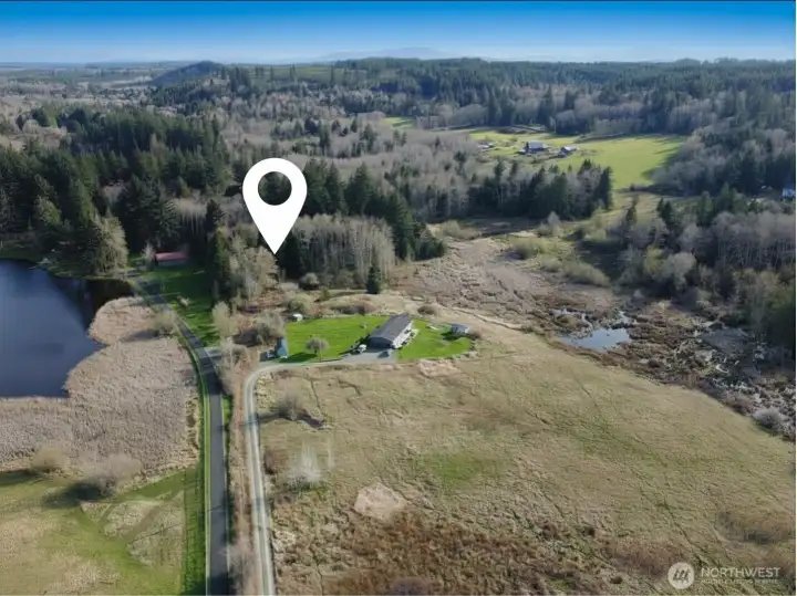Lot 2 Embody Road's access driveway is part of this parcel and then the parcel expands out past the neighbor's homesite on the right = where the white marker is located.