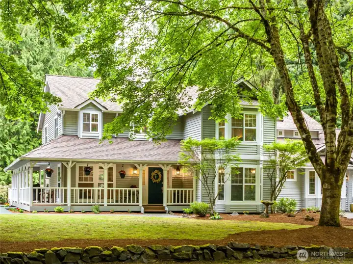 Beautiful home features a wrap-around covered porch.