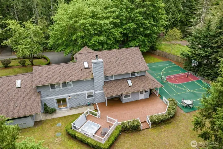 If you love outdoor activities...this is the home.  3 bedrooms, 2.25 bathrooms, 2 dens (one upstairs one on the main), a bonus room, and outside features the hot tub, sport court, playhouse (or shed), woods to play in and more.   Sport Court was just repainted on 6-3-26!  This is an enhanced old photo...the court looks better than this real-time.