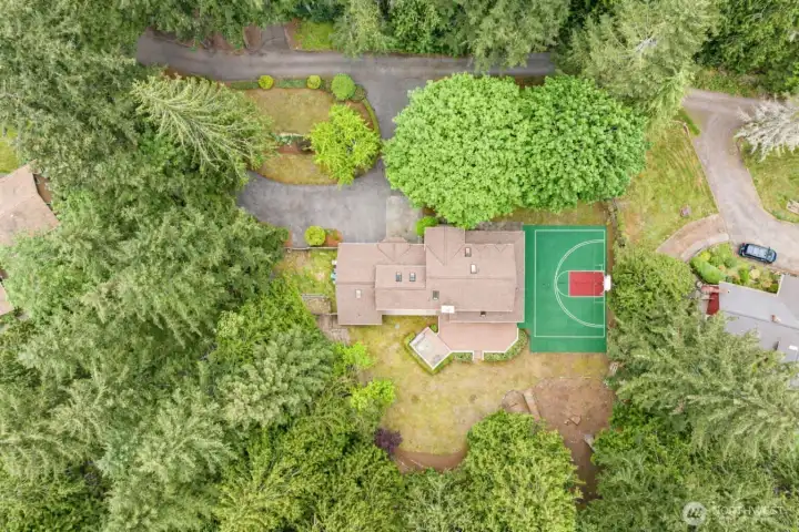 Great aerial view of the home...notice the circular driveway...Plenty of parking for your friends when they come to visit.  Such a fun place to gather with the sport court, spacious deck and hot tub, large yard, and bonus room for those rainy days too.