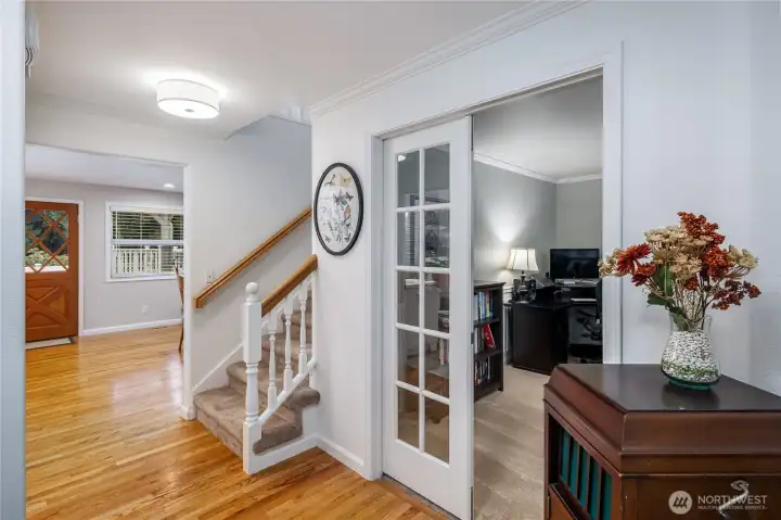 View from the main entry to the living room and double door entry den.
