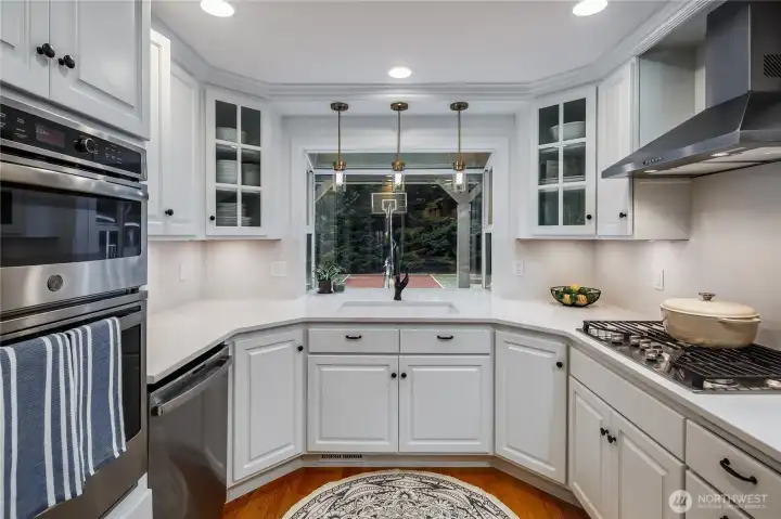 Beautifully updated kitchen with gas stove, stainless appliances and nice view of the sport court.