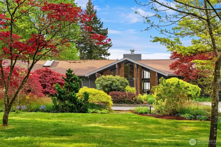 Privately sited on 5.5 manicured acres, this exceptional Vashon Island estate blends architectural sophistication with serene natural beauty.