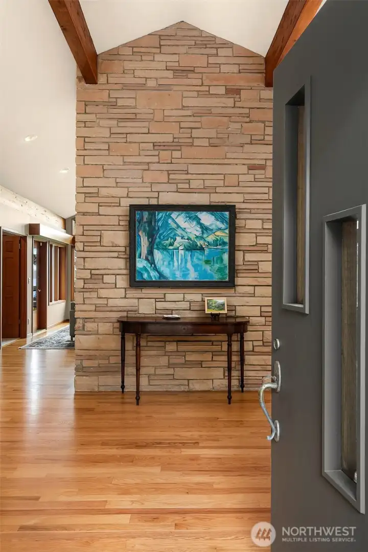 Beyond the front door, a sculptural entry hall introduces the home with a refined blend of stone, light and Northwest-inspired architecture.