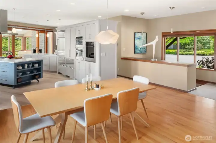 Professional-grade chef’s kitchen opens beautifully to dining, sunroom and outdoor gathering spaces.