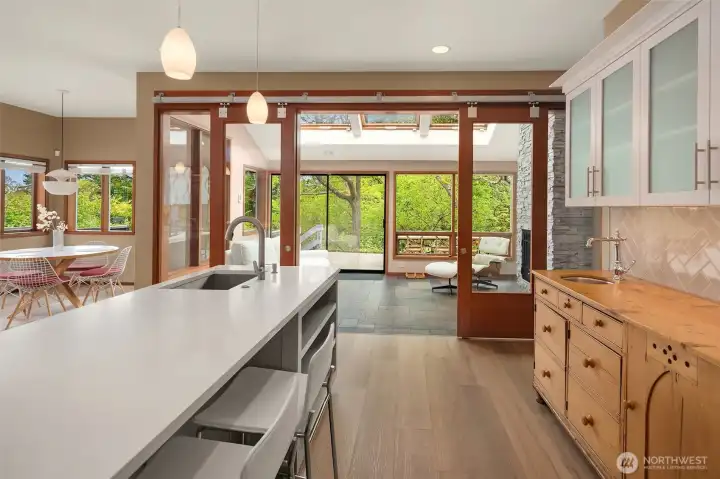 Rich with story and craftsmanship, the custom English pine bar adds soulful character to the chef’s kitchen and leads seamlessly to the garden fireside room.