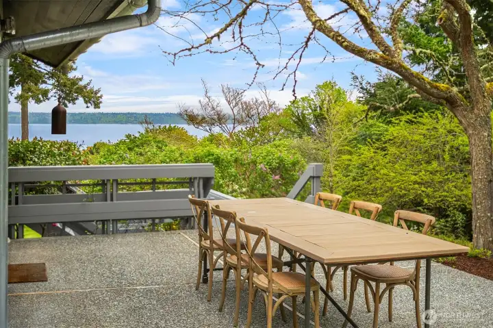 Private garden patio offers a magical setting for al fresco dining overlooking verdant gardens and Puget Sound views.