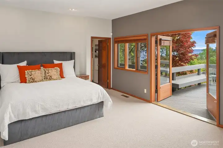 Wake to tranquil water views from the main-level primary suite with deck access.