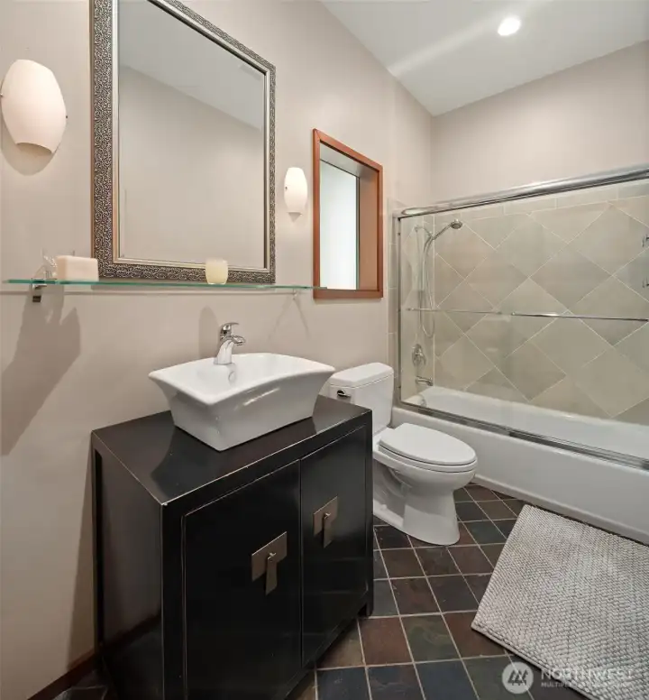 Well-appointed private bath serving the second main-level ensuite bedroom.
