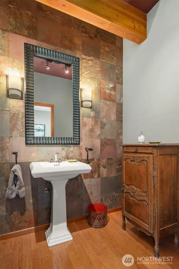 Artfully appointed powder room showcases rich natural materials and distinctive design.